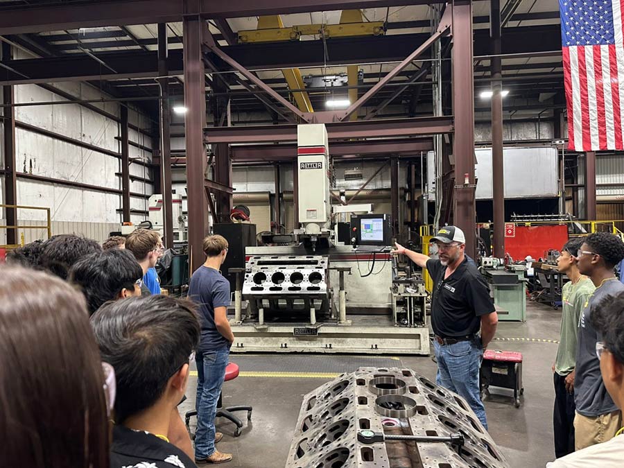 Corey McGuire and students at the HOLT CAT Longview Power Systems facility
