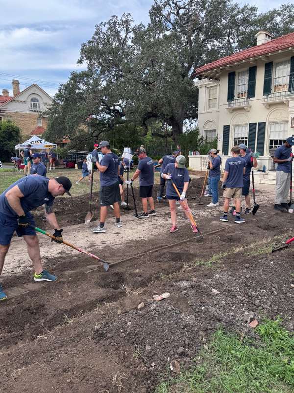 Volunteers break ground on a new landscaping area outside the Respite Care facility